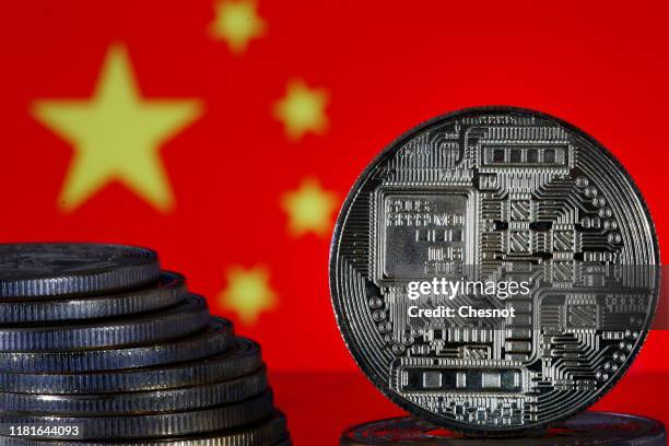 In this photo illustration, a visual representation of digital cryptocurrency coins sit on display in front of a Chinese flag on October 17, 2019 in...