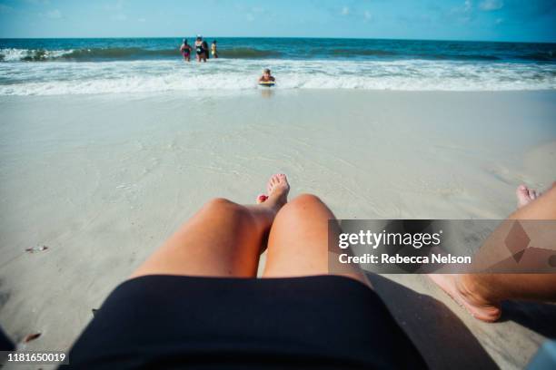 low section of woman and man in beach chairs at beach - rebecca da costa - fotografias e filmes do acervo