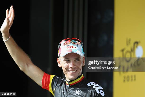 Belgium National Champion Philippe Gilbert of Omega Pharma Lotto waves as he stands on the podium to collect the King of the Mountains jersey after...