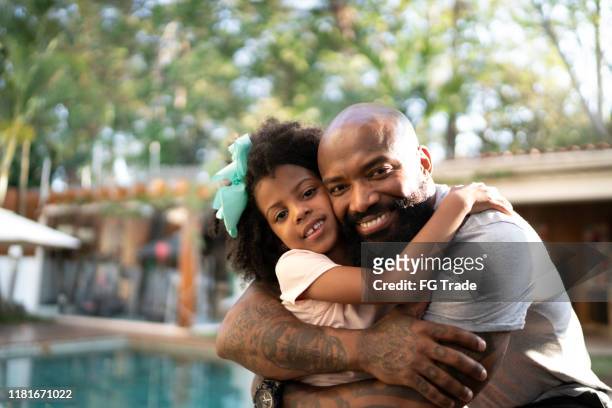 portrait of happy father hugging his daughter - bald child stock pictures, royalty-free photos & images