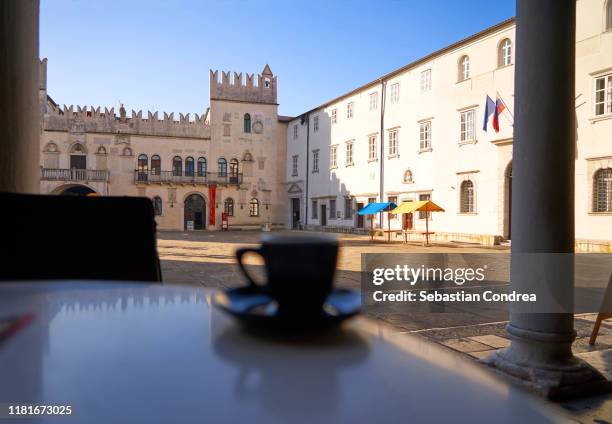 cup of coffe on table, square of the praetorian  gothic palace in the city of koper, slovenia. - koper slovenia stock pictures, royalty-free photos & images