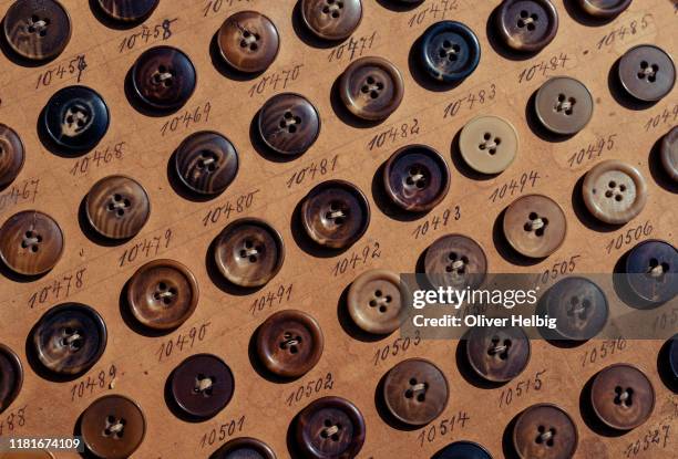 lot of vintage horn buttons on old cardboard from the 1930's - sastre fotografías e imágenes de stock