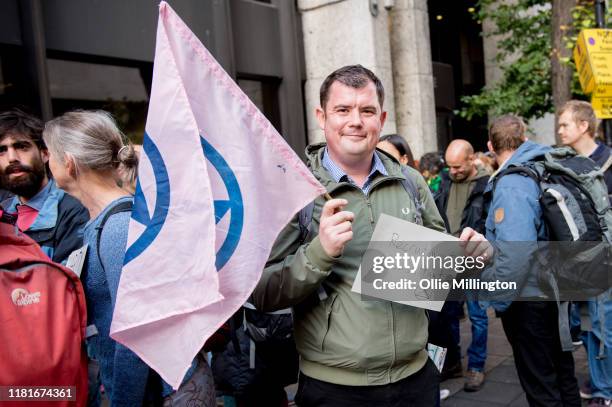 An Extinction Rebellion environmental activist and Recruitment Consultant protests outside the offices of The Department of Working Pensions on...