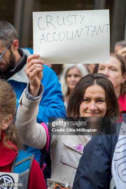 An Extinction Rebellion environmental activist and Accountant protests outside the offices of The Department of Working Pensions on October 17, 2019...
