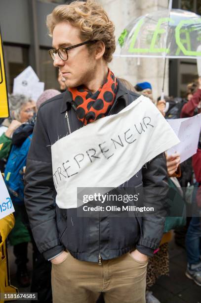 An Extinction Rebellion environmental activist and Entreprenuer protests outside the offices of The Department of Working Pensions on October 17,...