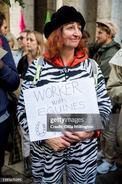An Extinction Rebellion environmental activist and Equine Worker protests outside the offices of The Department of Working Pensions on October 17,...