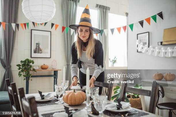preparing table for halloween lunch - draped table stock pictures, royalty-free photos & images