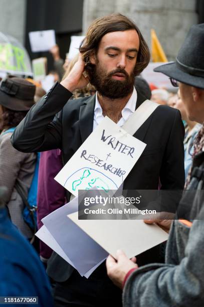 An Extinction Rebellion environmental activist, Writer and Researcher protests outside the offices of The Department of Working Pensions on October...