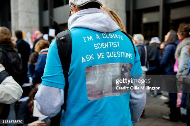An Extinction Rebellion environmental activist and Climate Scientist protests outside the offices of The Department of Working Pensions on October...