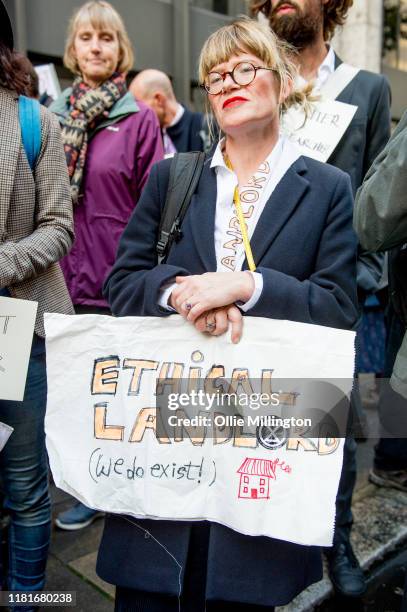 An Extinction Rebellion environmental activist protests outside the offices of The Department of Working Pensions during a gathering where they...