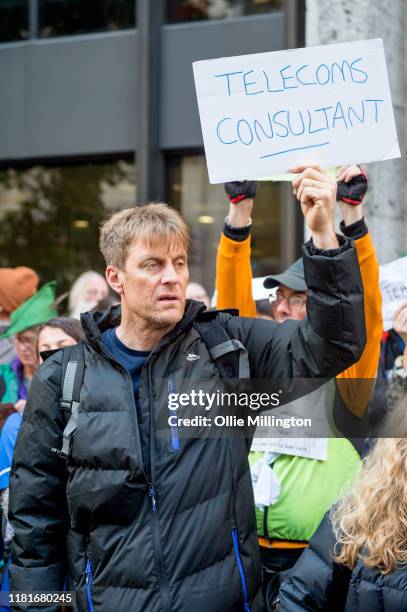 An Extinction Rebellion environmental activist and Telecoms Consultant protests outside the offices of The Department of Working Pensions on October...