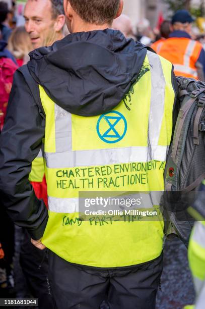 An Extinction Rebellion environmental activist and Health Practitioner protests outside the offices of The Department of Working Pensions on October...