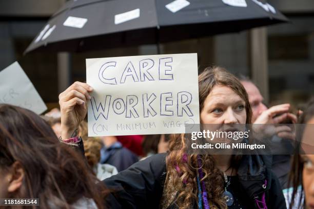 An Extinction Rebellion environmental activist and Care Worker protests outside the offices of The Department of Working Pensions on October 17, 2019...