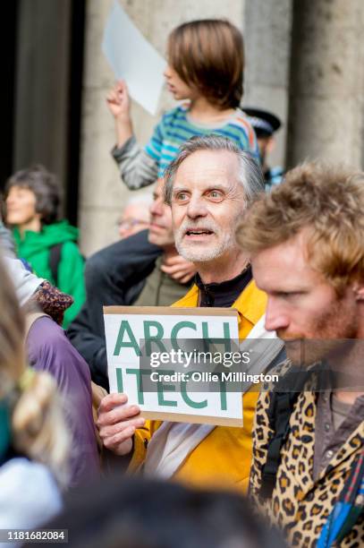 An Extinction Rebellion environmental activist and Architect protests outside the offices of The Department of Working Pensions on October 17, 2019...
