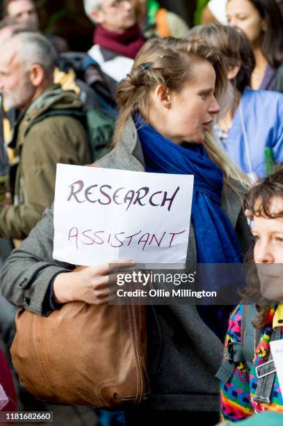 An Extinction Rebellion environmental activist and Research Assistant protests outside the offices of The Department of Working Pensions on October...