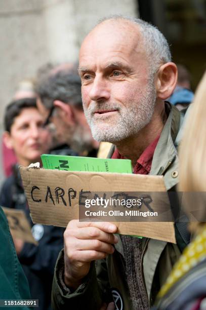 An Extinction Rebellion environmental activist protests outside the offices of The Department of Working Pensions during a gathering where they...