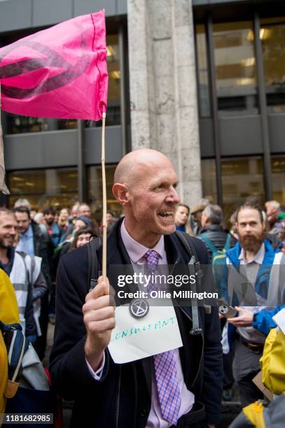 An Extinction Rebellion environmental activist protests outside the offices of The Department of Working Pensions on October 17, 2019 in London,...