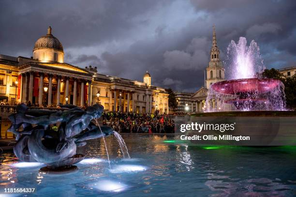 Extinction Rebellion environmental activists assemble at Trafalgar Square for speaches after a protests outside the offices of The Department of...