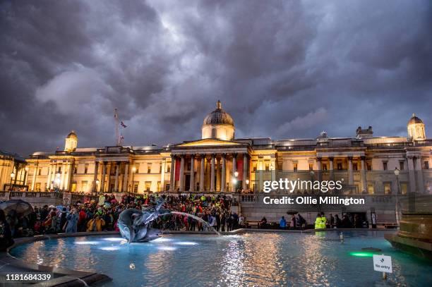 Extinction Rebellion environmental activists assemble at Trafalgar Square for speaches after a protests outside the offices of The Department of...