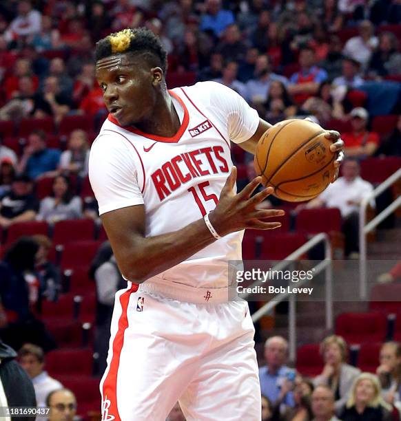 Clint Capela of the Houston Rockets grabs a rebound against the San Antonio Spurs during a preseason game at Toyota Center on October 16, 2019 in...