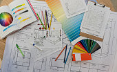 Blue prints, color swatch, pencil colors, sketches, plans and documents for a home renovation