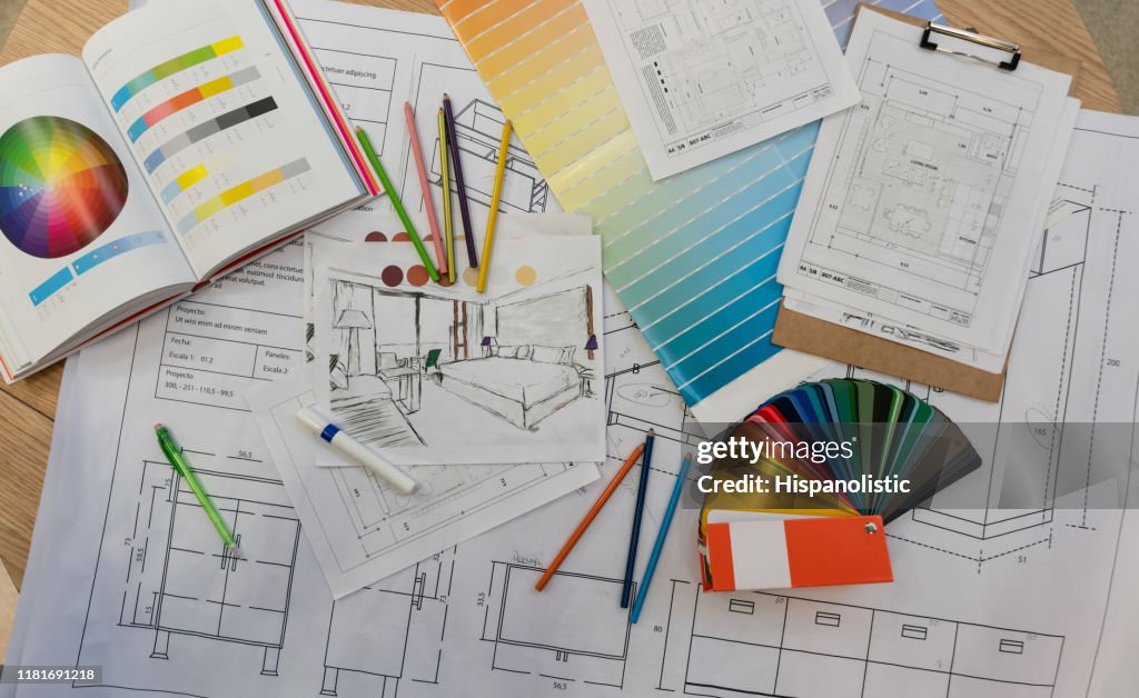 Blue prints, color swatch, pencil colors, sketches, plans and documents for a home renovation