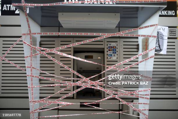 Picture taken on on November 11 shows an ATM which has been sealed by Lebanese anti-government protesters in the capital Beirut during a rally...