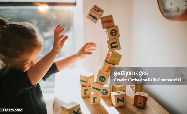 child pushing blocks - anti gravity stock pictures, royalty-free photos & images