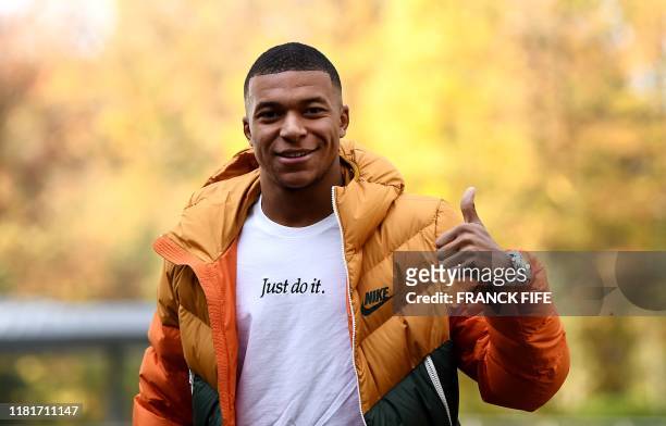 France's forward Kylian Mbappe arrives at the French national football team training base in Clairefontaine en Yvelines on November 11 as part of the...