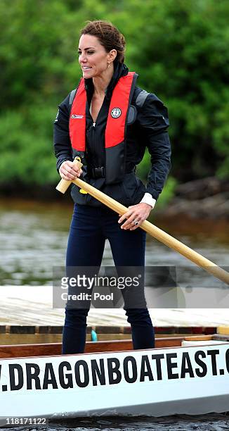 Catherine, Duchess of Cambridge steers a dragon baot before a race against her husband across the Dalvay lake on July 4, 2011 in Charlottetown,...