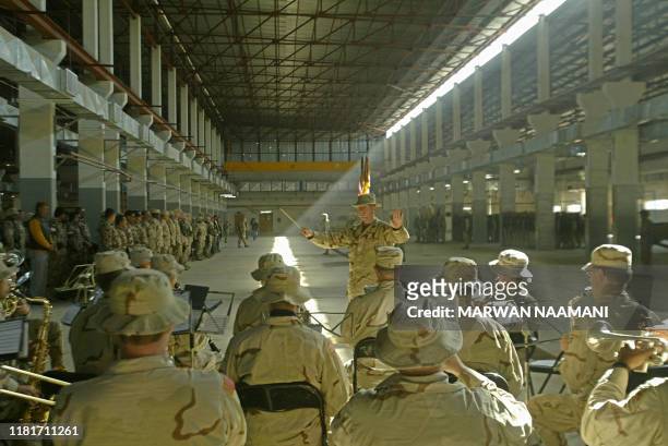 Army band performs songs during a transfer of authority ceremony at the American base in Abu Gharib area, west of Baghdad 10 February 2004. The 2nd...