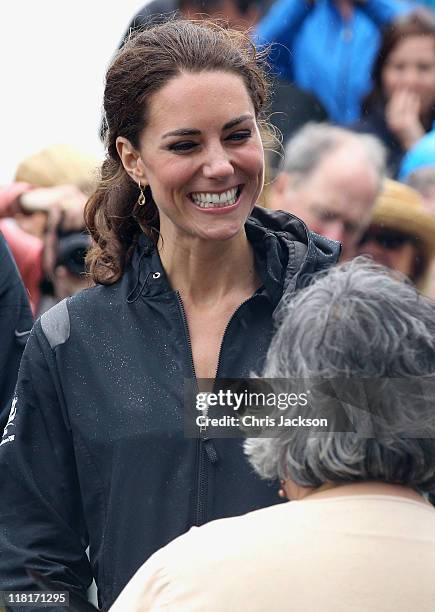 Catherine, Duchess of Cambridge takes part in a smudging ceremony as she arrives on shore after rowing dragon boats across Dalvay lake on July 4,...