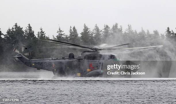 Prince William, Duke of Cambridge takes part in a demonstration of waterbirding during an exercise in a Sea King Helicopter on July 4, 2011 in...