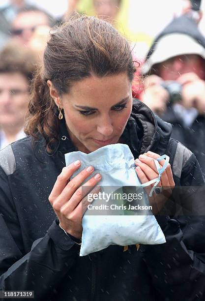 Catherine, Duchess of Cambridge takes part in a smudging ceremony as she arrives on shore after rowing dragon boats across Dalvay lake on July 4,...