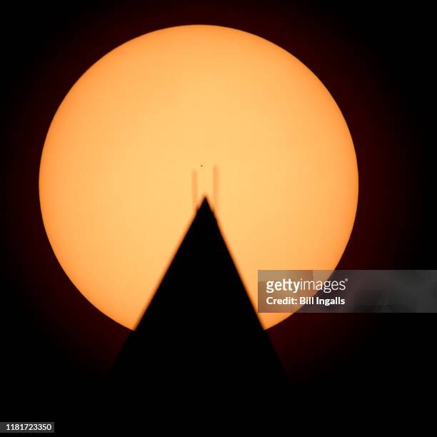In this handout provided by NASA, the planet Mercury is seen in silhouette, center, as it transits across the face of the Sun, behind the Washington...