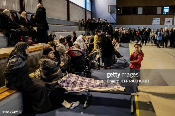 Woman lays in a cot as people gather in a gymnasium in Le Teil, southeastern France, on November 11 after an earthquake with a magnitude of 5.4 hit...