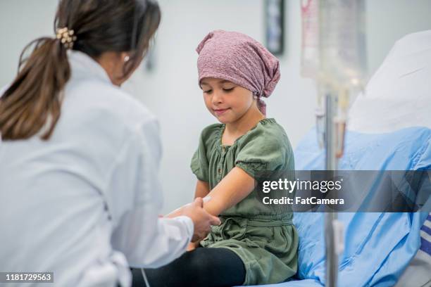 little girl receiving chemotherapy treatment stock photo - doctor coat stock pictures, royalty-free photos & images