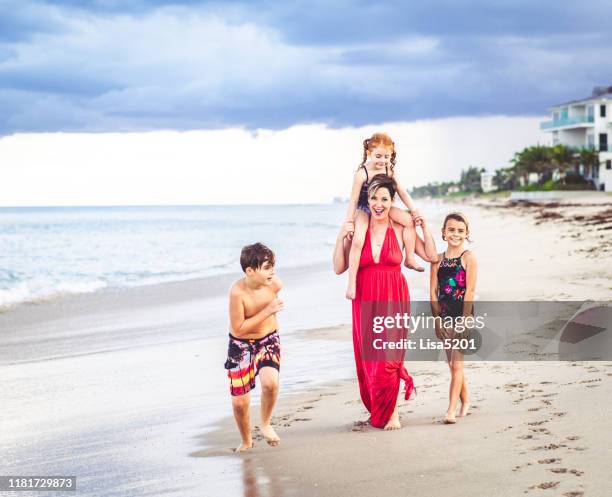 beautiful silly family enjoys an idyllic beach - boca raton stock pictures, royalty-free photos & images