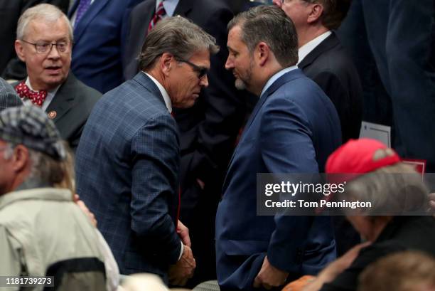 Secretary of Energy Rick Perry walks past U.S. Sen. Ted Cruz as he exits as President Donald Trump speaks during a "Keep America Great" Campaign...