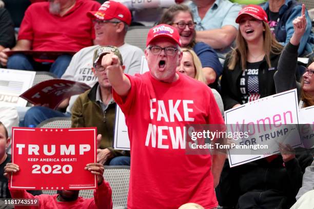 Supporters react as U.S. President Donald Trump speaks during a "Keep America Great" Campaign Rally at American Airlines Center on October 17, 2019...