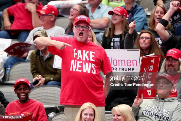 Supporters react as U.S. President Donald Trump speaks during a "Keep America Great" Campaign Rally at American Airlines Center on October 17, 2019...