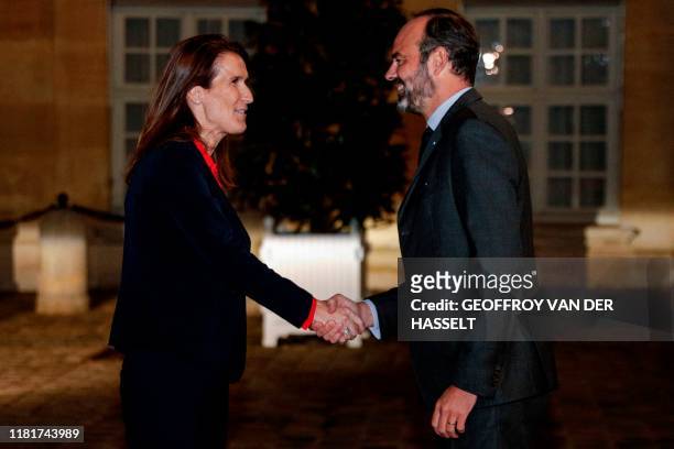 Belgian Prime Minister Sophie Wilmes shakes hands with French Prime Minister Edouard Philippe as she arrives at the Hotel Matignon in Paris, on...