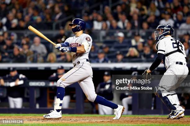 Carlos Correa of the Houston Astros hits a three-run home run against the New York Yankees during the sixth inning in game four of the American...