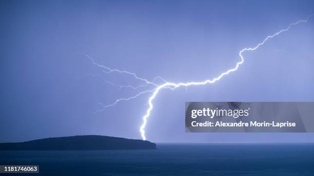 lightning striking the picturesque dream-like sun island (isla del sol) in the middle of the titikaka lake in bolivia - lightening bolt backgrounds stock pictures, royalty-free photos & images