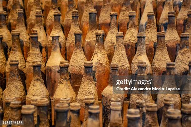 background of many old bottles with cement, stacked one behind the other - multi barrel stock pictures, royalty-free photos & images