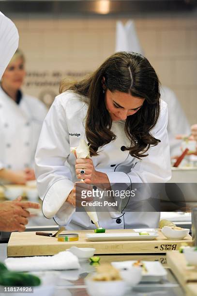 Catherine, Duchess of Cambridge takes part in a cooking workshop at the Institut De Tourisme et D'hotellerie Du Quebec on July 2, 2011 in Montreal,...