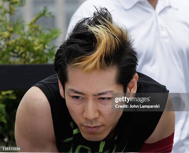 Takeru Kobayashi challeges 2011 Nathan's Famous Hot Dog Eating Competition contestants via satellite at 230 Fifth Avenue on July 4, 2011 in New York...