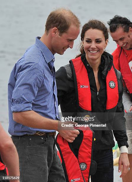 Prince William, Duke of Cambridge and Catherine, Duchess of Cambridge arrive on shore after rowing dragon boats across Dalvay lake on July 4, 2011 in...