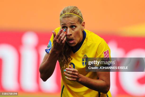 Sweden's striker Lotta Schelin replaces a contact lens during the Sweden vs France FIFA women's football World Cup match for third place at the...