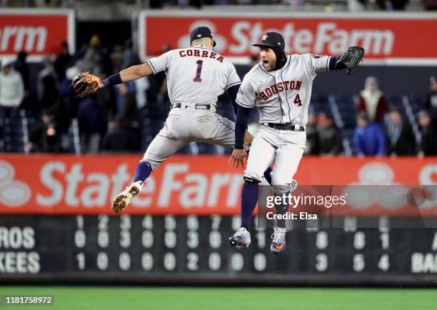 Carlos Correa and George Springer of the Houston Astros celebrate their teams 8-3 win over the New York Yankees in game four of the American League...